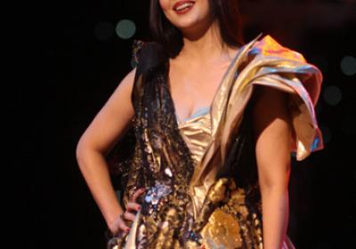 Mariam Tamari in a gold dress